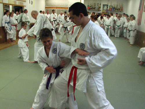 Children learning how to do takedown in a karate class.